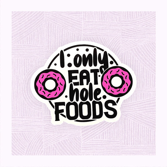 Die cut sticker with the phrase ‘I only eat hole foods’ with a pink doughnut either side.