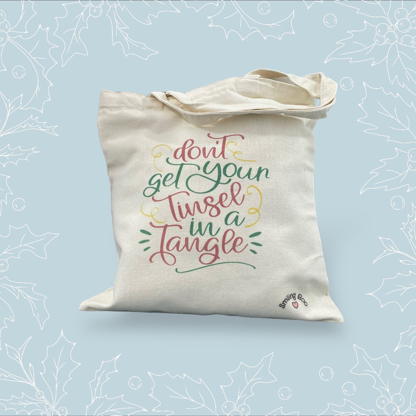 Canvas tote bag with ‘Don’t get you tinsel in a tangle’ in festive colours and font