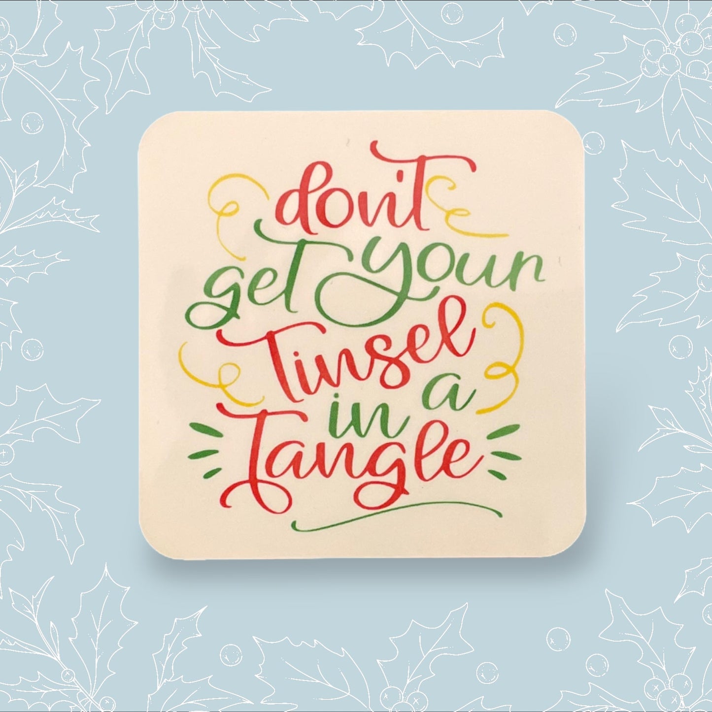 Square coaster with ‘Don’t get you tinsel in a tangle’ in festive colours and font