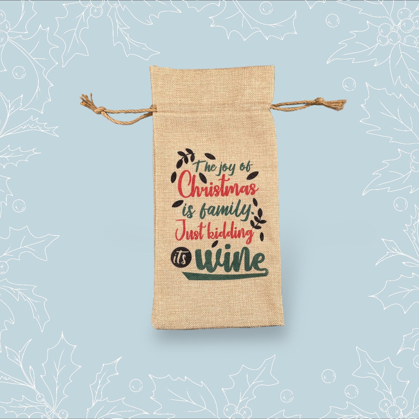 A burlap bottle bag with the phrase ‘The joy of Christmas is family. Just kidding, it’s wine’