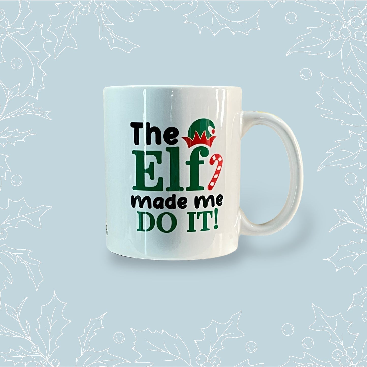 Ceramic mug with ‘The elf made me do it’ on it, and Christmas print on the handle and inside the mug