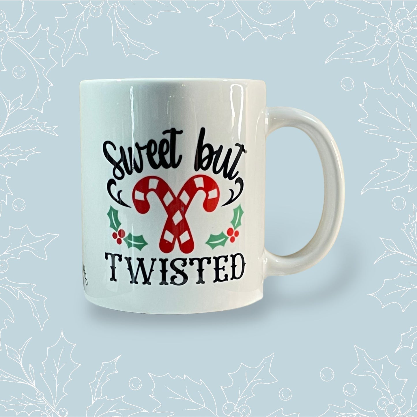 Ceramic mug with ‘Sweet but Twisted’ and two crossed candy canes