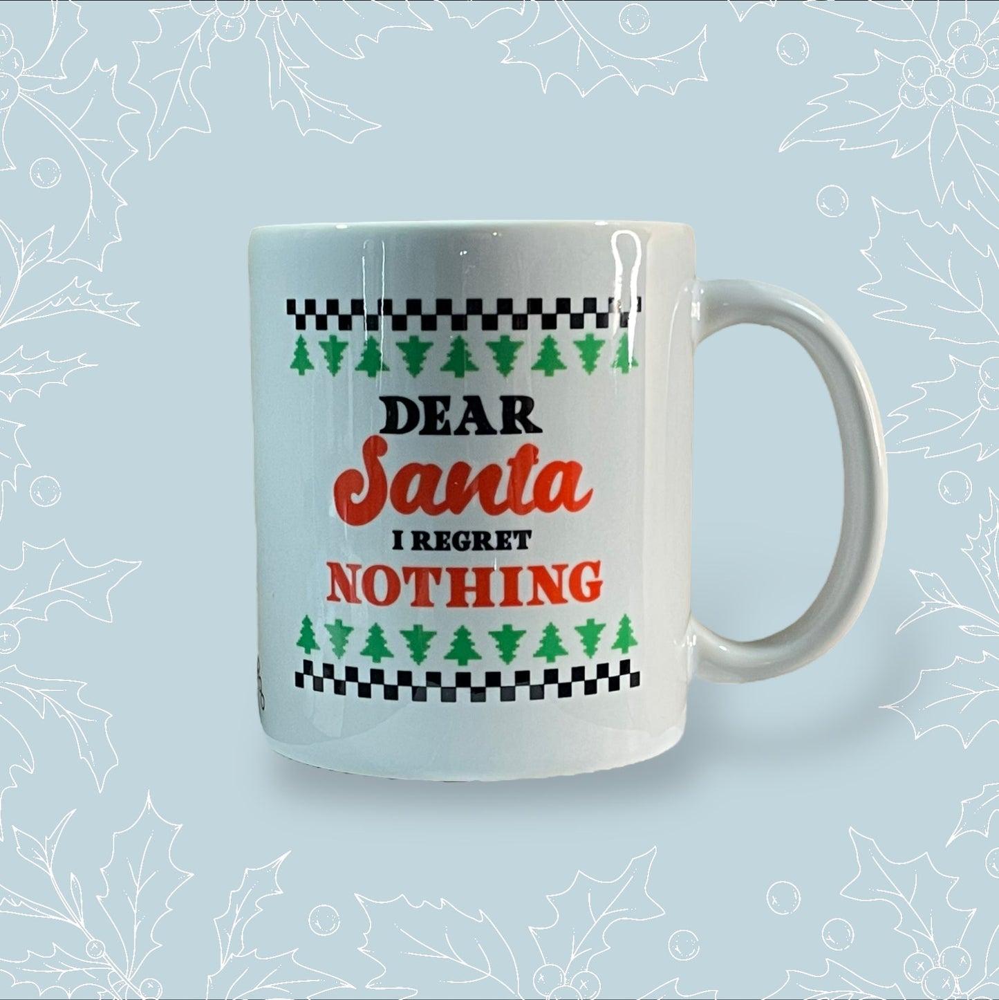 Ceramic mug with ‘Dear Santa, I regret nothing’ on it in the style of a Christmas jumper