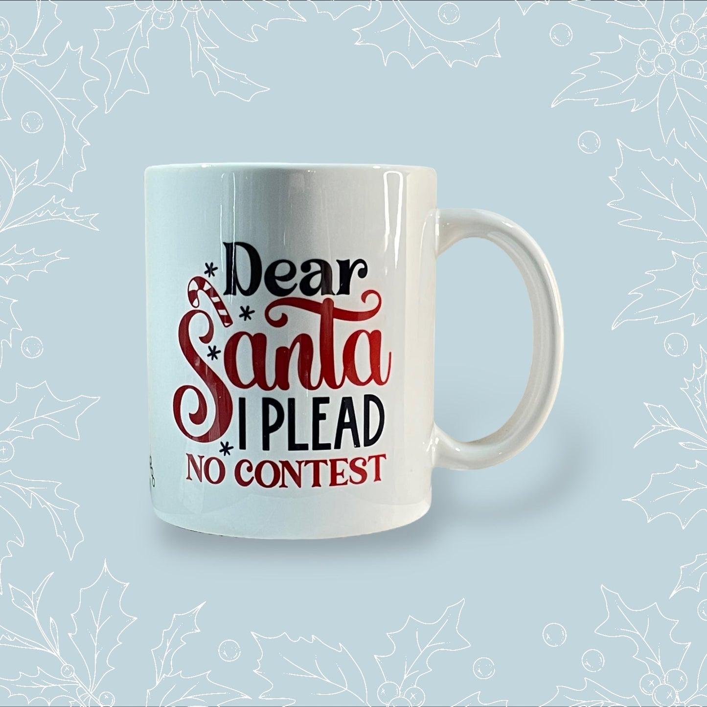 Ceramic mug with ‘Dear Santa, I plead no contest’ in black and red with festive embellishments