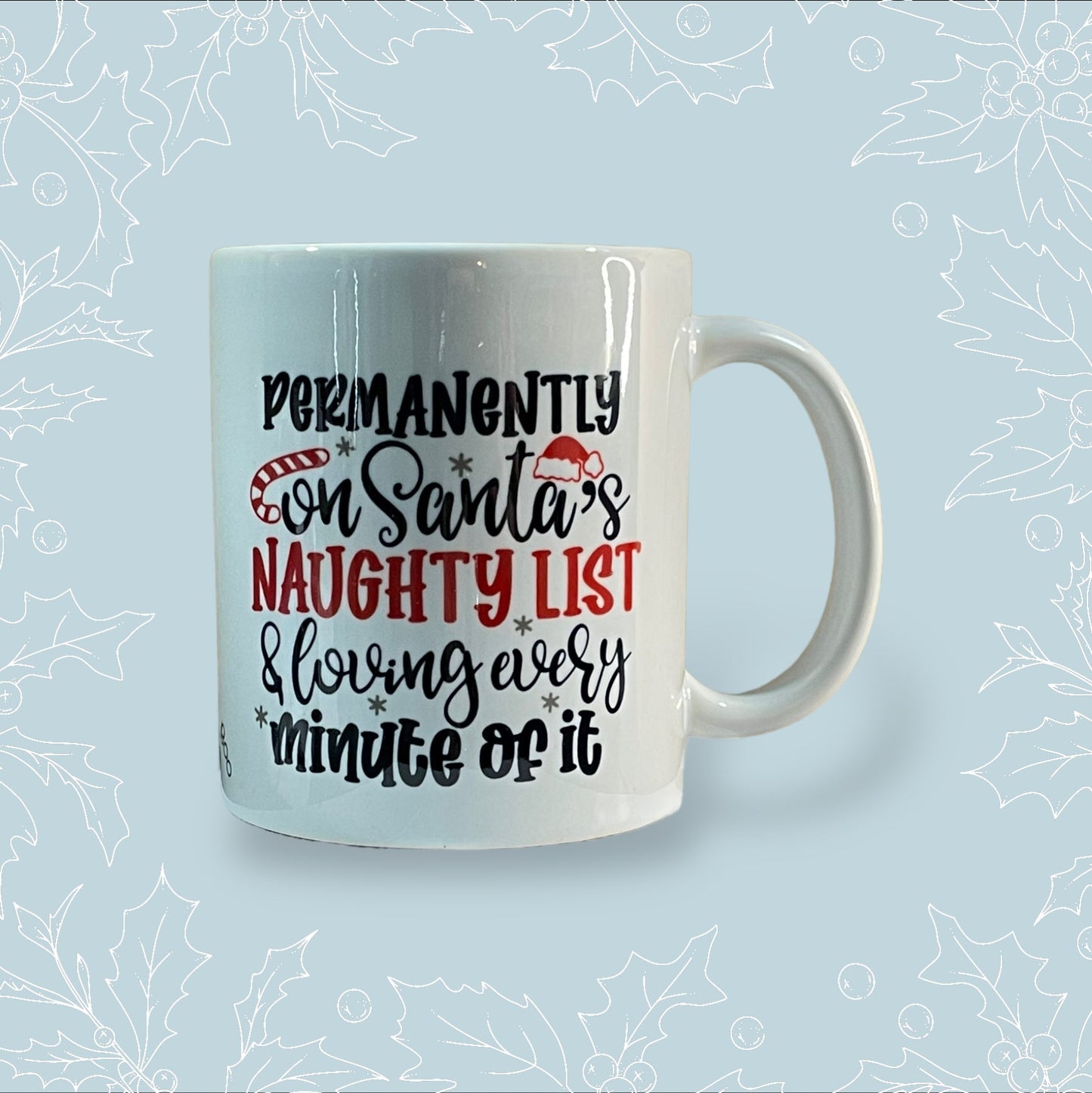 Ceramic mug with ‘Permanently on Santa’s naughty list and loving every minute of it in black and red embellishments