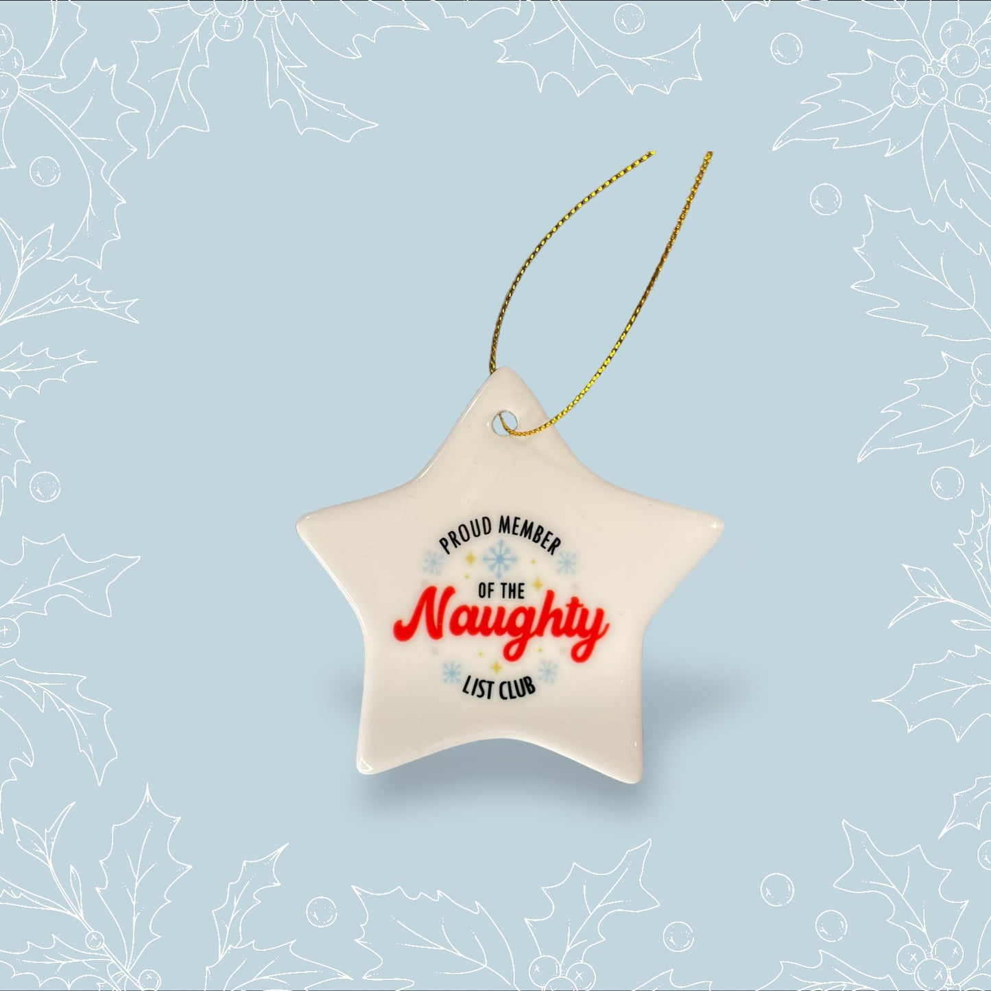 A ceramic star hanging tree ornament with ‘Proud member of the naughty list club’