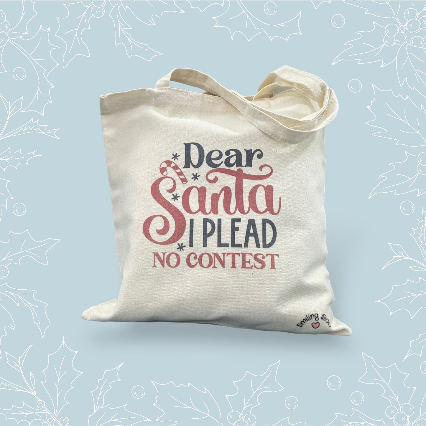 Canvas tote bag with ‘Dear Santa, I plead no contest’ in black and red with festive embellishments