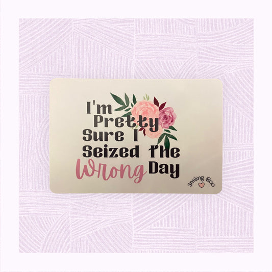 Postcard art print with a pastel pink/peach watercolour background with the phrase ‘I’m pretty sure I seized the wrong day’ and floral arrangement