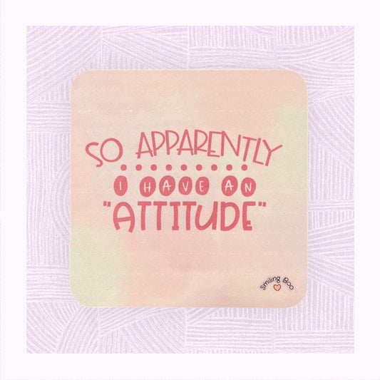 Square coaster with a pastel pink background and the phrase ‘Apparently I have an Attitude’ in bubble font.