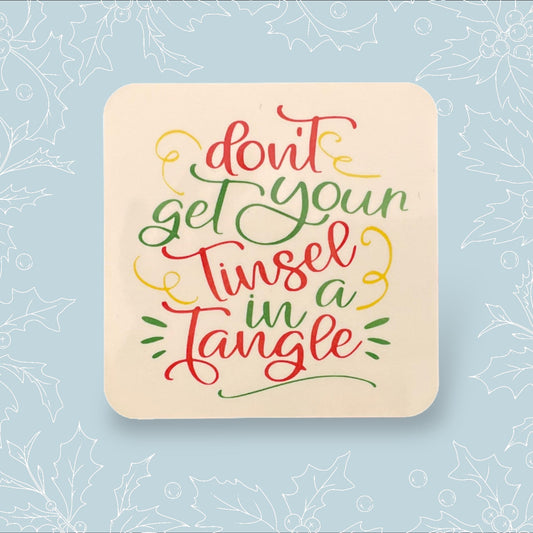 Square coaster with ‘Don’t get you tinsel in a tangle’ in festive colours and font