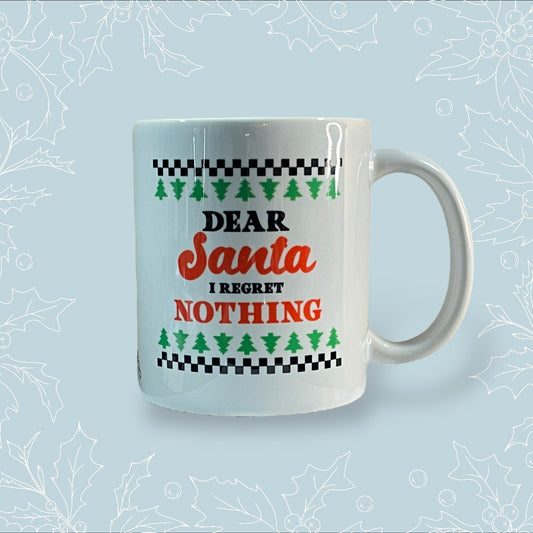 Ceramic mug with ‘Dear Santa, I regret nothing’ on it in the style of a Christmas jumper